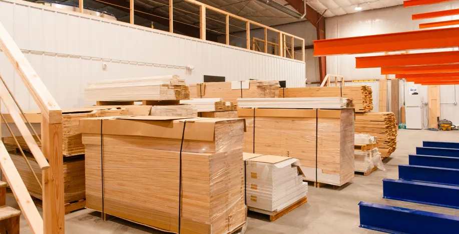 Big Sky Doors Montana facility with organized stacks of wood materials ready for door manufacturing.
