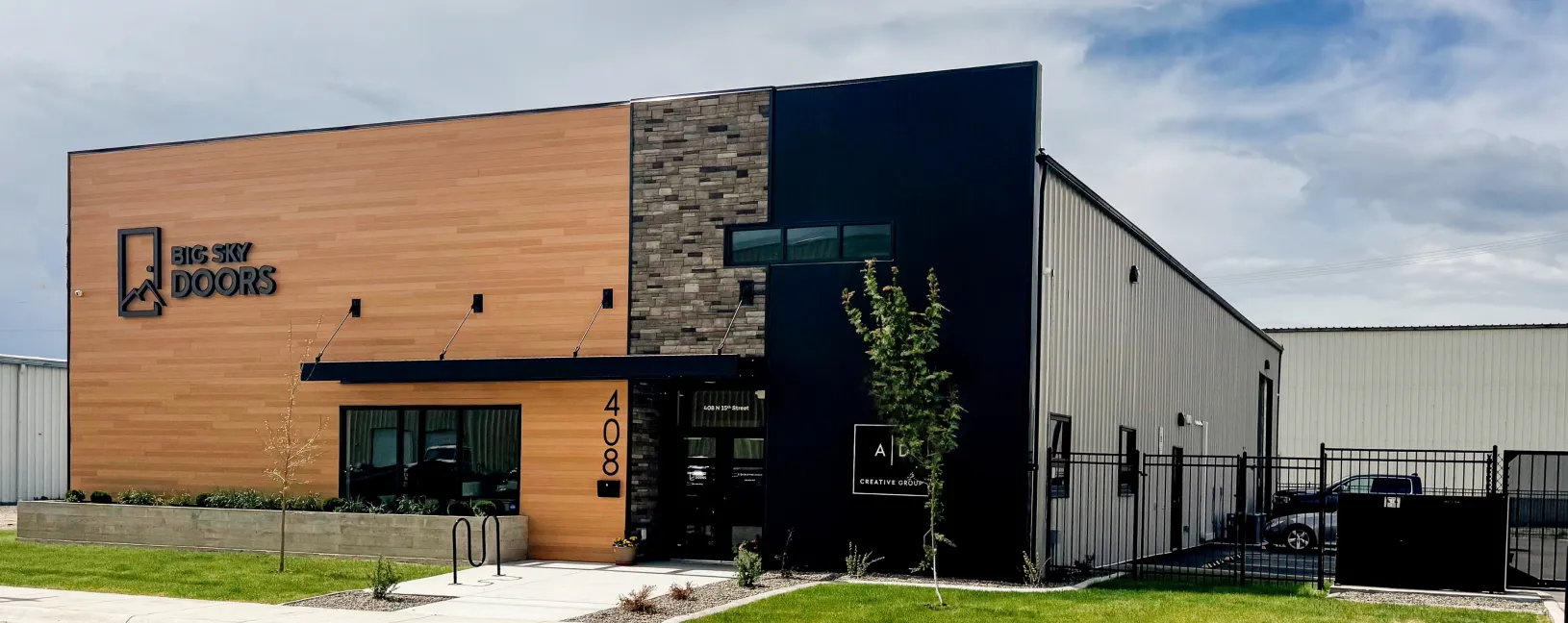 “Modern Big Sky Doors headquarters exterior featuring wood and stone design in Montana.