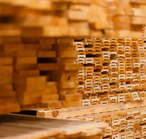 Close-up view of stacked wood panels prepared for custom door production at Big Sky Doors in Montana.